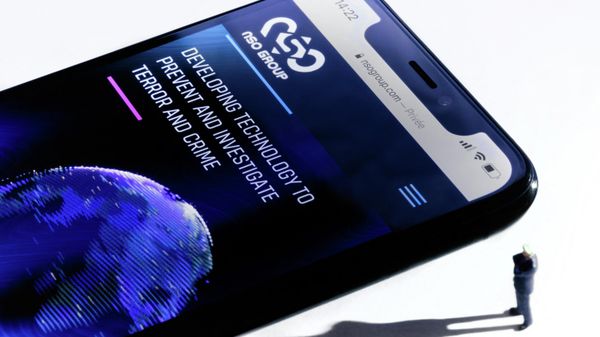 This studio photographic illustration shows a smartphone with the website of Israel's NSO Group which features 'Pegasus' spyware, on display in Paris on July 21, 2021. - Private Israeli firm NSO Group has denied media reports its Pegasus software is linked to the mass surveillance of journalists and rights defenders, and insisted that all sales of its technology are approved by Israel's defence ministry - Sputnik International