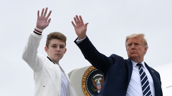 President Donald Trump, right, and his son Barron Trump wave from the top of the steps to Air Force One at Morristown Municipal Airport in Morristown, N.J. - Sputnik International