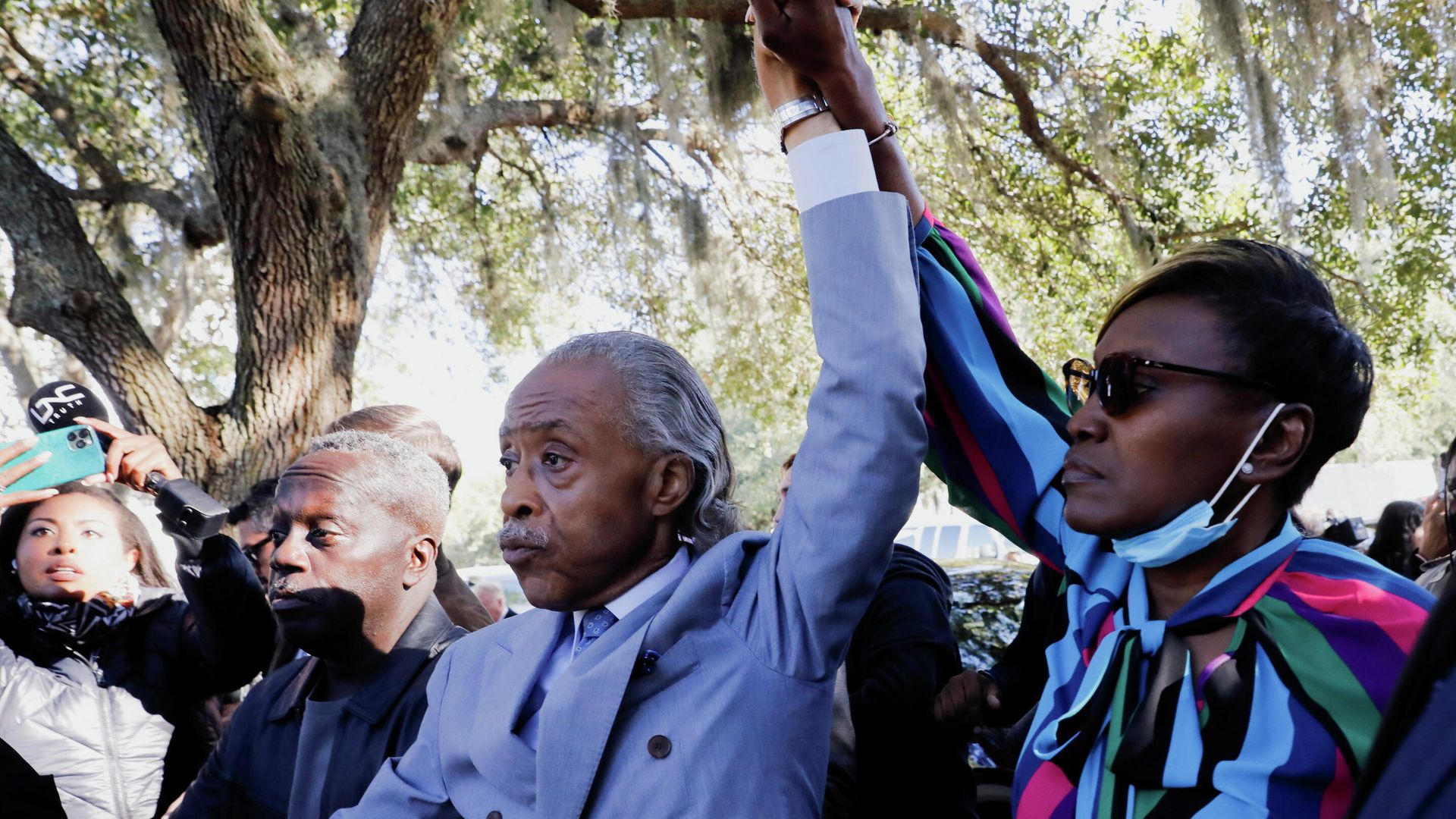 Reverend Al Sharpton and Wanda Cooper-Jones, mother of Ahmaud Arbery, raise their hands outside the Glynn County Courthouse after the jury reached a guilty verdict in the trial of William Roddie Bryan, Travis McMichael and Gregory McMichael, charged with the February 2020 death of 25-year-old Ahmaud Arbery, in Brunswick, Georgia, U.S., November 24, 2021. Reverend Al Sharpton and Wanda Cooper-Jones, mother of Ahmaud Arbery, raise their hands outside the Glynn County Courthouse after the jury reached a guilty verdict in the trial of William Roddie Bryan, Travis McMichael and Gregory McMichael, charged with the February 2020 death of 25-year-old Ahmaud Arbery, in Brunswick, Georgia, U.S., November 24, 2021. - Sputnik International, 1920, 24.11.2021