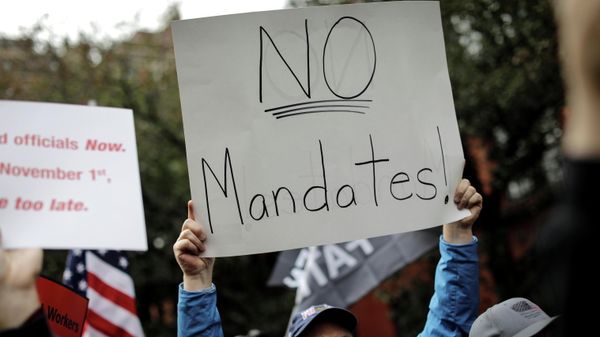 A demonstrator holds a sign during a protest by New York City Fire Department (FDNY) union members, municipal workers and others, against the city's COVID-19 vaccine mandates on Manhattan's Upper East Side, in New York City, New York, U.S., October 28, 2021. - Sputnik International