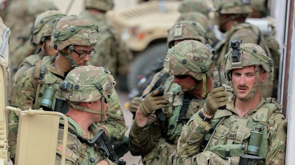 Soldiers with the 45th Infantry Brigade Combat Team, Oklahoma Army National Guard, stand in formation preparing to move towards a safehouse during a training exercise at the National Training Center in Fort Irwin, California, July 21, 2021. Members of the 45th IBCT are participating in the Battle of Razish located in a mock-town that simulates a war-like experience and includes a fight from the on post opposing force with the intent of increasing readiness among Soldiers.  - Sputnik International