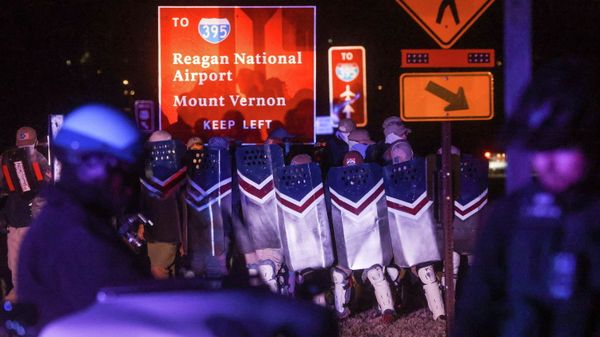 Members of the white supremacist group Patriot Front stand with shields as a law enforcement officers stand guard between them and media members and bystanders, in Arlington, Virginia, U.S. December 4, 2021.  - Sputnik International