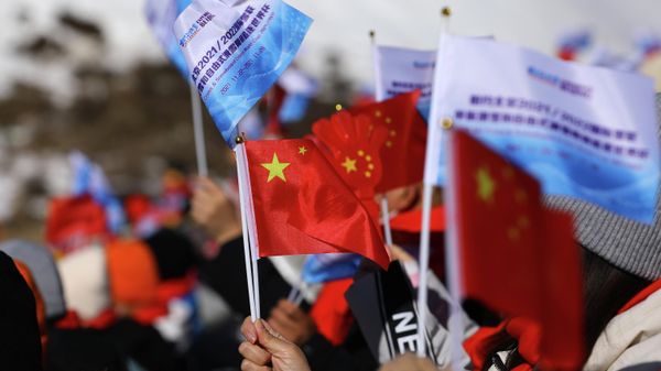 Skiing - Beijing 2022 Winter Olympics - FIS Ski Cross World Cup - Genting Snow Park, Zhangjiakou, China - November 27, 2021 Spectators hold Chinese flags before the competition - Sputnik International