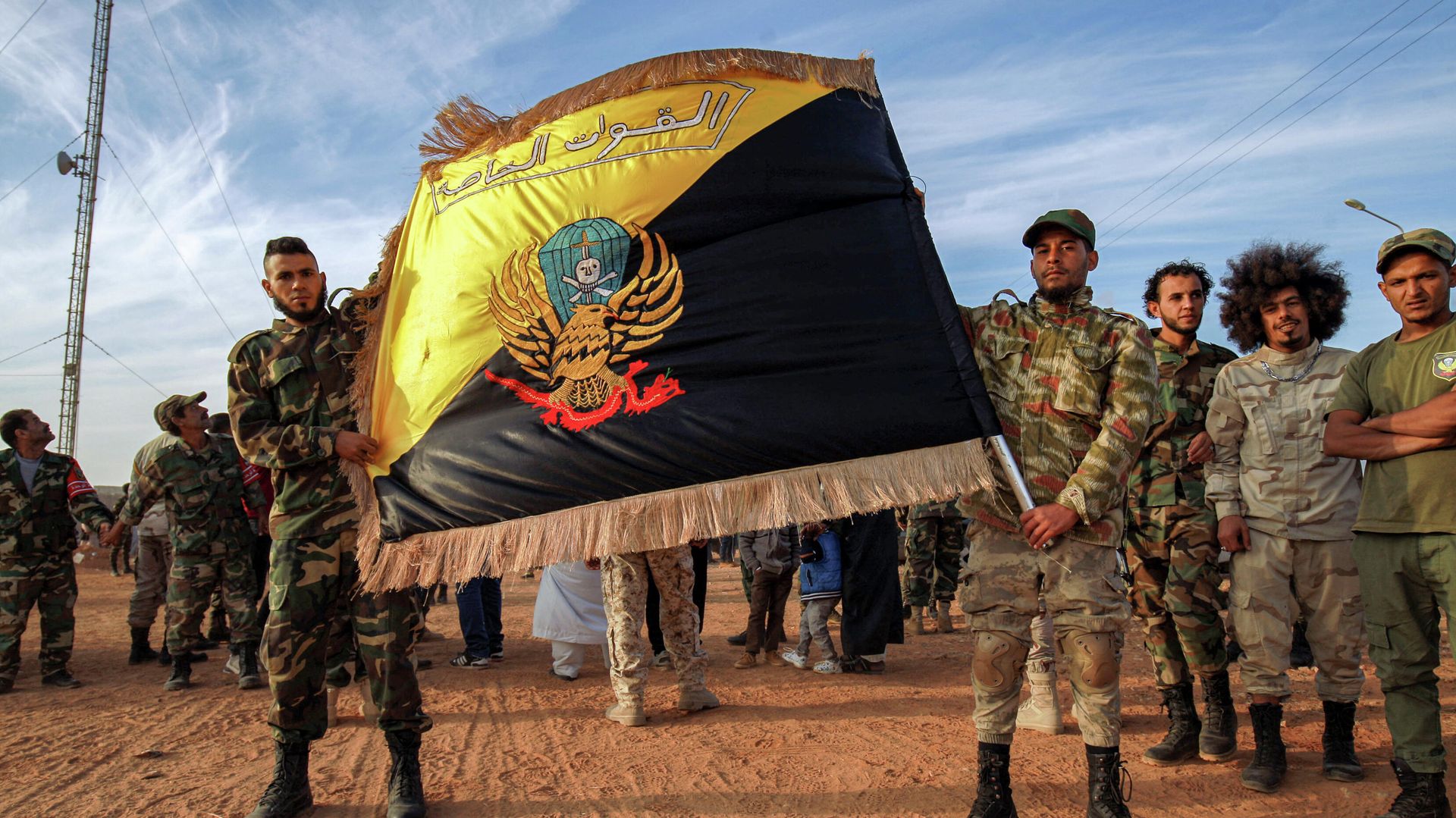 Members of the the Saiqa (Special Forces) of the self-proclaimed Libyan National Army (LNA), loyal to eastern strongman Khalifa Haftar, pose with their flag during an event in tribute to the unit's late commander General Wanis Bukhamada, who died a week prior, in the eastern city of Benghazi on November 6, 2020. Members of the the Saiqa (Special Forces) of the self-proclaimed Libyan National Army (LNA), loyal to eastern strongman Khalifa Haftar, pose with their flag during an event in tribute to the unit's late commander General Wanis Bukhamada, who died a week prior, in the eastern city of Benghazi on November 6, 2020. - Sputnik International, 1920, 11.12.2021