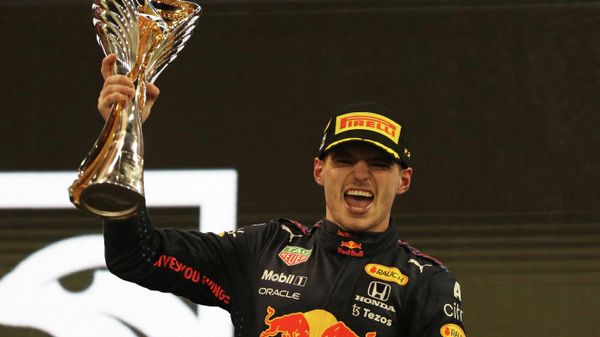 Formula One F1 - Abu Dhabi Grand Prix - Yas Marina Circuit, Abu Dhabi, United Arab Emirates - December 12, 2021 Red Bull's Max Verstappen celebrates winning the race and the world championship on the podium with the trophy - Sputnik International