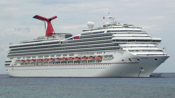 Carnival Freedom is in the harbor at George Town, Grand Cayman. It is one of Carnival's ships entering cruise service in 2007. It has a lot of balconies. The ship is 952 ft (290 m) long. It lists capacity of carries 2,900 passengers, which might be the meximum if extra capacity in cabins is used. I took this photo from the shore. - Sputnik International