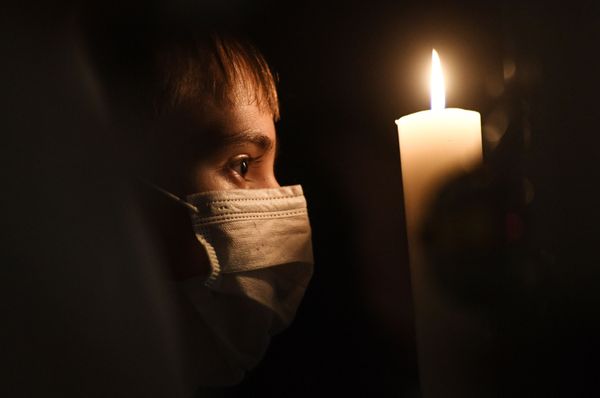 A mask-wearing boy looks thoughtful during a Christmas mass at a Catholic church in Novosibirsk. A mask-wearing boy looks thoughtful during a Christmas mass at a Catholic church in Novosibirsk. - Sputnik International