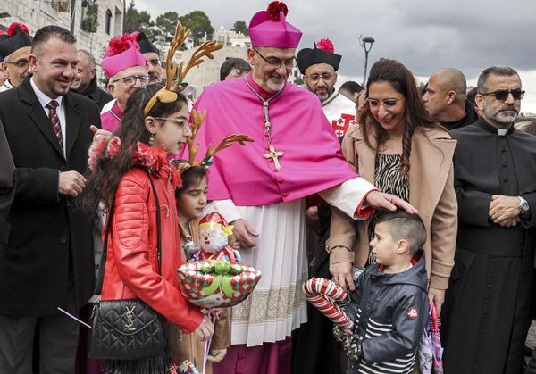 Pierbattista Pizzaballa (C), the Latin Patriarch of Jerusalem, greets children as he arrives at the Church of Nativity during Christmas celebrations in the biblical city of Bethlehem in the occupied West Bank on Christmas eve on 24 December 2021. Pierbattista Pizzaballa (C), the Latin Patriarch of Jerusalem, greets children as he arrives at the Church of Nativity during Christmas celebrations in the biblical city of Bethlehem in the occupied West Bank on Christmas eve on 24 December 2021. - Sputnik International