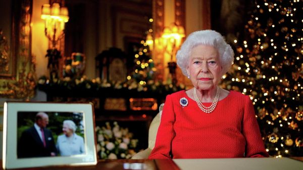 FILE PHOTO: Britain's Queen Elizabeth records her annual Christmas broadcast in the White Drawing Room in Windsor Castle, next to a photograph of the queen and the Duke of Edinburgh, in Windsor, Britain, December 23, 2021. - Sputnik International