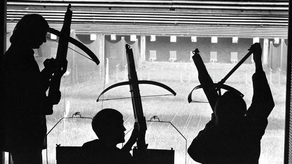 Participants in he crossbow shooting event of the European championships are silhouetted against the targets as he competitors prepare their gear in Munich, Aug. 14, 1975 - Sputnik International