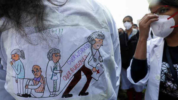 A person with a sign stands as resident doctors with Centre-run government hospitals participate in a protest called by the Federation of Resident Doctors' Association (FORDA) over the delay in National Eligibility cum Entrance Test Postgraduate (NEET-PG) 2021 counselling, outside Nirman Bhawan, in New Delhi - Sputnik International