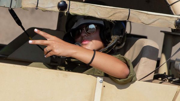 An Israeli female soldier flashes a victory sign while siting in a military vehicle during an exercise in the Israeli controlled Golan Heights near the border with Syria, Tuesday, Aug. 4, 2020.  - Sputnik International