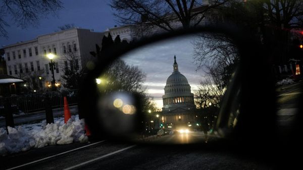 A view of the U.S. Capitol at sunset reflected in a car window on January 5, 2022 in Washington, DC. Congress is preparing to mark the one year anniversary of the January 6 Capitol riot on Thursday. - Sputnik International
