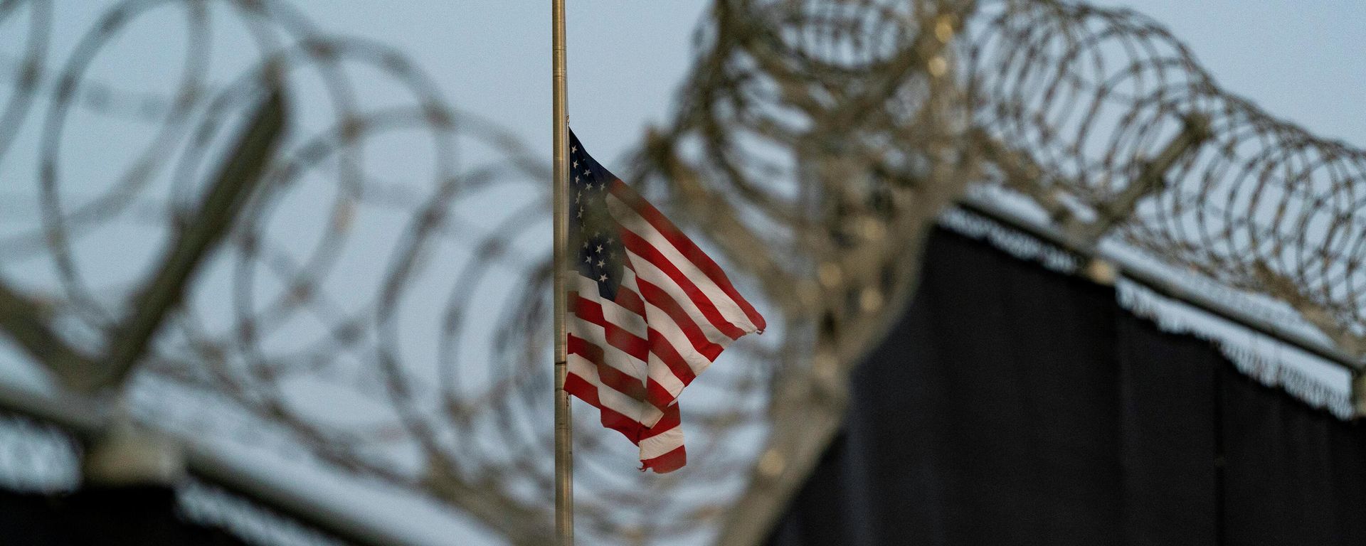In this Aug. 29, 2021, file photo reviewed by U.S. military officials, a flag flies at half-staff in honor of the U.S. service members and other victims killed in the terrorist attack in Kabul, Afghanistan, as seen from Camp Justice in Guantanamo Bay Naval Base, Cuba. In this Aug. 29, 2021, file photo reviewed by U.S. military officials, a flag flies at half-staff in honor of the U.S. service members and other victims killed in the terrorist attack in Kabul, Afghanistan, as seen from Camp Justice in Guantanamo Bay Naval Base, Cuba. - Sputnik International, 1920, 10.01.2023