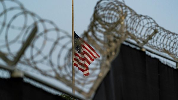 In this Aug. 29, 2021, file photo reviewed by U.S. military officials, a flag flies at half-staff in honor of the U.S. service members and other victims killed in the terrorist attack in Kabul, Afghanistan, as seen from Camp Justice in Guantanamo Bay Naval Base, Cuba. - Sputnik International