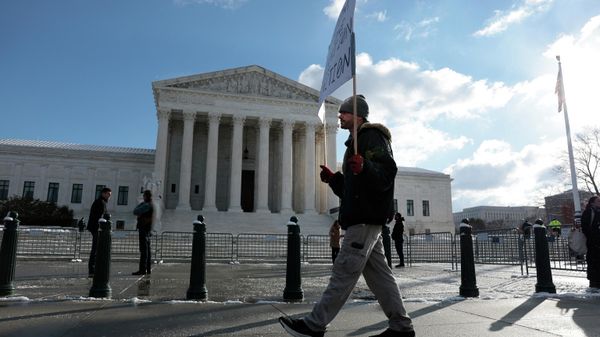 A protester holds a sign that reads Freedom is one generation from Extinction as he walks by the U.S. Supreme Court on Capitol Hill on January 07, 2022 in Washington, DC. Today the Justices of the Supreme Court are hearing arguments against U.S. President Joe Biden’s private sector Covid-19 vaccination rules. - Sputnik International