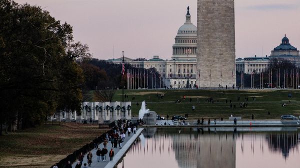 The U.S. Capitol Building is seen past the Washington Monument as people walk around the Reflecting Pool on the National Mall as the sun sets on November 28, 2021 in Washington, DC. President Biden returned to Washington after spending the Thanksgiving Holiday with family in Nantucket and immediately met with members of his medical team to discuss the newly discovered Omicron variant of the coronavirus. - Sputnik International