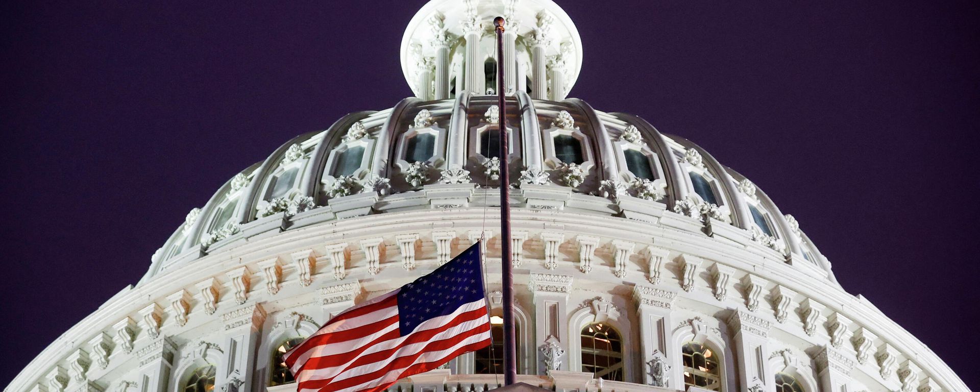 A flag of the United States is seen at halfstaff on the U.S. Capitol building during a prayer vigil in observance of the first anniversary of the January 6, 2021 attack on the Capitol by supporters of former President Donald Trump, on Capitol Hill in Washington, U.S., January 6, 2022. REUTERS/Jonathan Ernst A flag of the United States is seen at halfstaff on the U.S. Capitol building during a prayer vigil in observance of the first anniversary of the January 6, 2021 attack on the Capitol by supporters of former President Donald Trump, on Capitol Hill in Washington, U.S., January 6, 2022. REUTERS/Jonathan Ernst - Sputnik International, 1920, 13.01.2022