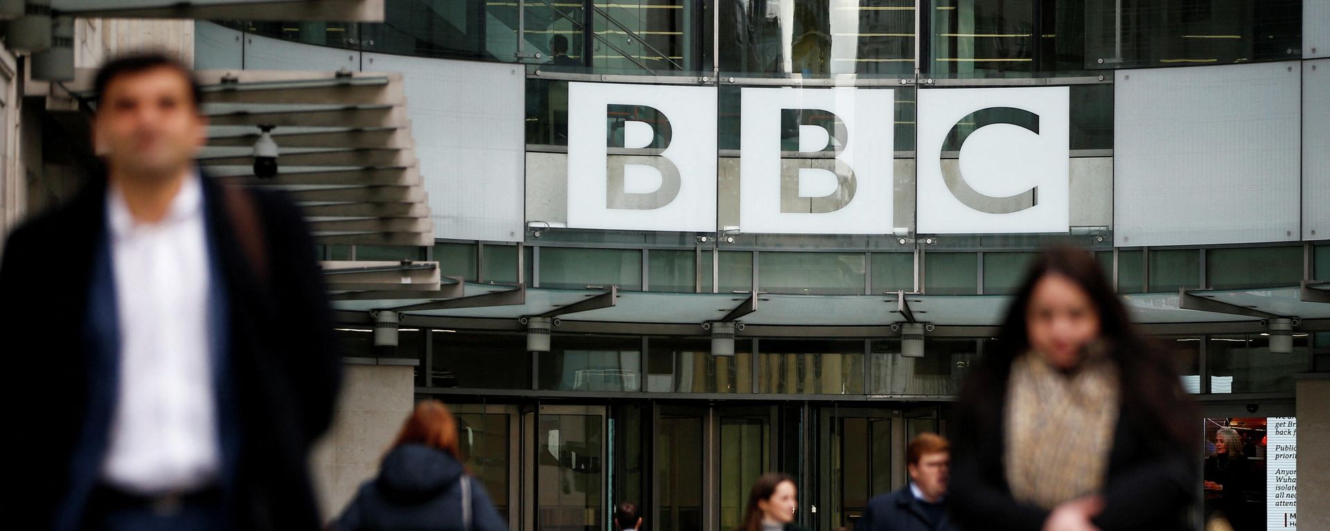 FILE PHOTO: Pedestrians walk past a BBC logo at Broadcasting House, as the corporation announced it will cut around 450 jobs from its news division, in London FILE PHOTO: Pedestrians walk past a BBC logo at Broadcasting House, as the corporation announced it will cut around 450 jobs from its news division, in London - Sputnik International, 1920, 16.01.2022