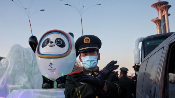 A paramilitary police officer gestures at the photographer in front of the mascot of the Beijing 2022 Winter Olympics in Beijing, China, January 15, 2022 A paramilitary police officer gestures at the photographer in front of the mascot of the Beijing 2022 Winter Olympics in Beijing, China, January 15, 2022 - Sputnik International