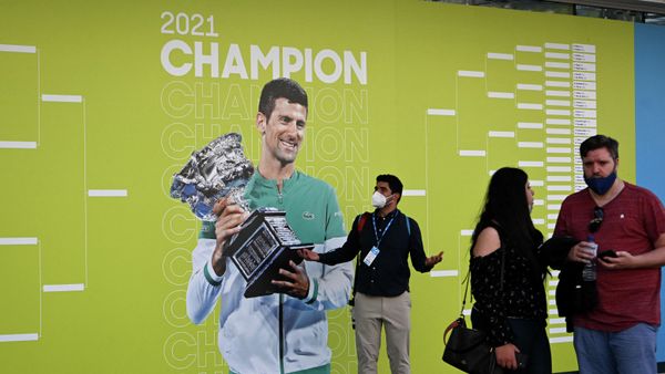 Tennis - Australian Open - Melbourne Park, Melbourne, Australia - January 17, 2022 People are seen in front of an image of Novak Djokovic on the first day of the Australian Open at Melbourne Park - Sputnik International