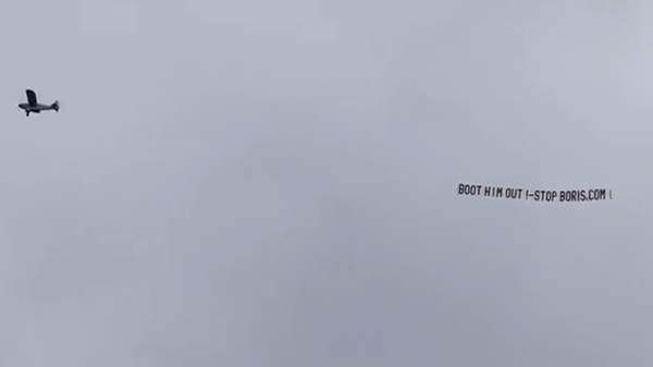 A screenshot of a light aircraft brandishing the anti-Boris Johnson banner Boot him out  - Sputnik International
