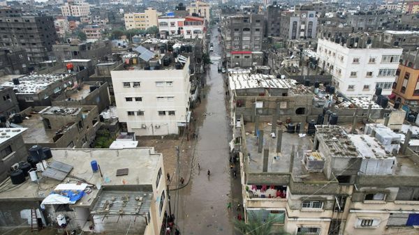 Palestinian children wade through a flooded road following heavy rains in the northern Gaza Strip, January 16, 2022. Picture taken with a drone.  - Sputnik International