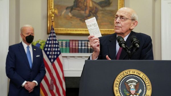 U.S. Supreme Court Justice Stephen Breyer holds up a copy of the U.S. Constitution, while President Joe Biden looks on, as Breyer announces he will retire at the end of the court's current term, at the White House in Washington, U.S. - Sputnik International