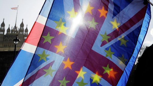 In this file photo dated Wednesday, Jan. 29, 2020, an anti-Brexit campaigner waves European Union and British Union flags outside Parliament in London - Sputnik International