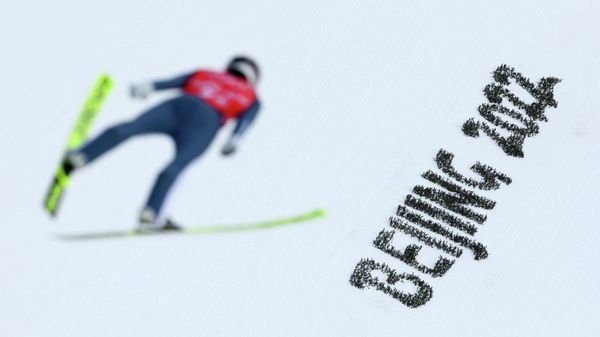 National Ski Jumping Centre, Zhangjiakou, China - February 4, 2022. An athlete competes next to plants arranged to read Beijing 2022.  - Sputnik International