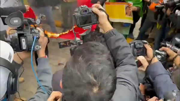 Demonstrators, said to be from the Tibetan Youth Congress, burn the flag of China near the country's embassy in India. - Sputnik International