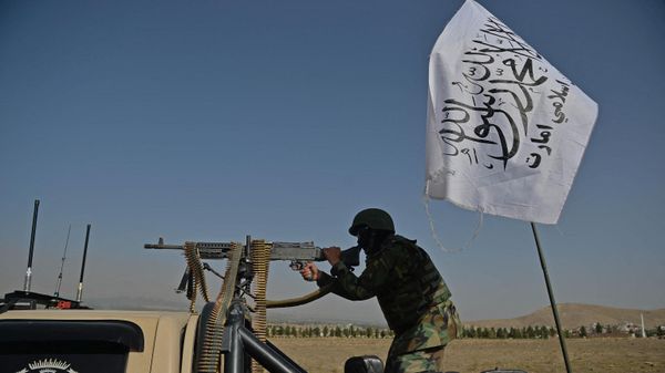 A Taliban fighter stands guard in a vehicle near the venue of an open-air rally in a field on the outskirts of Kabul on October 3, 2021, as the Taliban supporters and senior figures held their first mass rally in a show of strength as they consolidate their rule of Afghanistan.  - Sputnik International