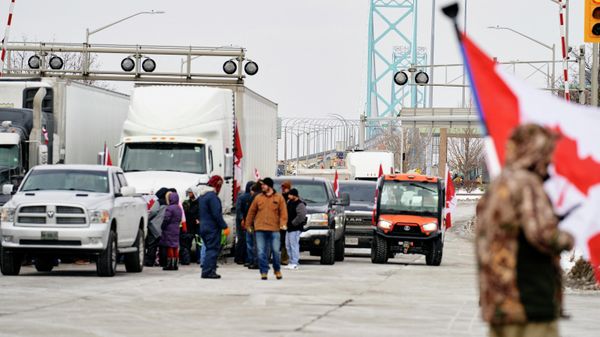 Supporters of the Truckers Convoy against the Covid-19 vaccine mandate block traffic in Canada bound lanes of the Ambassador Bridge border crossing, in Windsor, Ontario, on February 8, 2022. - Sputnik International