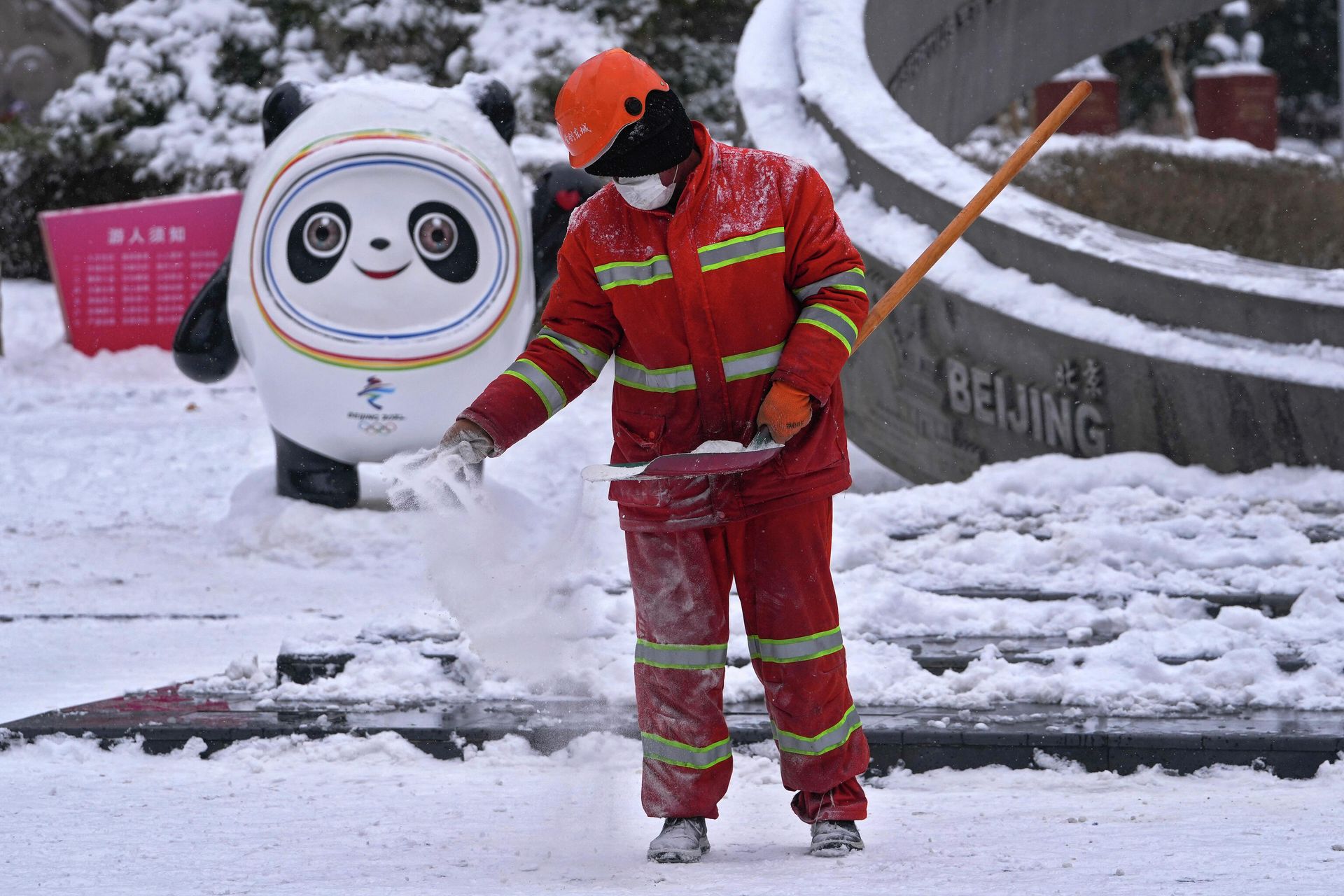 A worker sprays salt on the snow to prevent slipping near the Bing Dwen Dwen, the Beijing Winter Olympics mascot, on display at an Olympics monument during a snow fall in Beijing, Sunday, Feb. 13, 2022. A worker sprays salt on the snow to prevent slipping near the Bing Dwen Dwen, the Beijing Winter Olympics mascot, on display at an Olympics monument during a snow fall in Beijing, Sunday, Feb. 13, 2022. - Sputnik International, 1920, 13.02.2022
