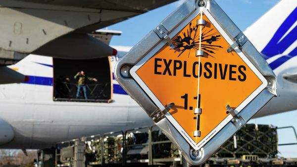 Senior Airman Cameron Manson, 436th Aerial Port Squadron ramp services specialist, watches a marshaller for directions as he aligns a cargo loader with an aircraft during a foreign military sales mission with Ukraine at Dover Air Force Base, Delaware, Feb. 10, 2022. - Sputnik International