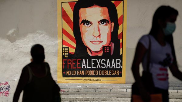 FILE - In this Sept 9, 2021 file photo, pedestrians walk near a poster asking for the freedom of Colombian businessman and Venezuelan special envoy Alex Saab, in Caracas, Venezuela. The Venezuelan government added Saab on Tuesday, September 14, 2021, to the negotiation team that is meeting with the opposition in Mexico. Saab has was detained in Cabo Verde a year ago and is facing extradition to the US for money laundering. FILE - In this Sept 9, 2021 file photo, pedestrians walk near a poster asking for the freedom of Colombian businessman and Venezuelan special envoy Alex Saab, in Caracas, Venezuela. The Venezuelan government added Saab on Tuesday, September 14, 2021, to the negotiation team that is meeting with the opposition in Mexico. Saab has was detained in Cabo Verde a year ago and is facing extradition to the US for money laundering. - Sputnik International