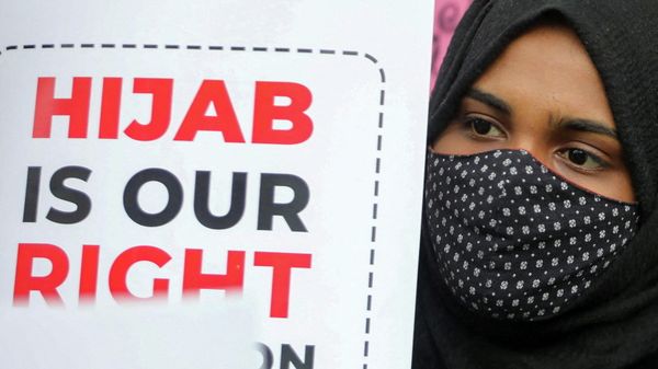 A Muslim student holds a placard during a protest by the Muslim Students Federation (MSF) against the recent hijab ban in  Karnataka’s schools, in New Delhi, India, February 8, 2022.  - Sputnik International