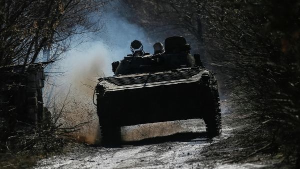 Ukrainian service members ride an infantry fighting vehicle on the front line near the village of Zaitseve in the Donetsk region, Ukraine February 19, 2022 - Sputnik International