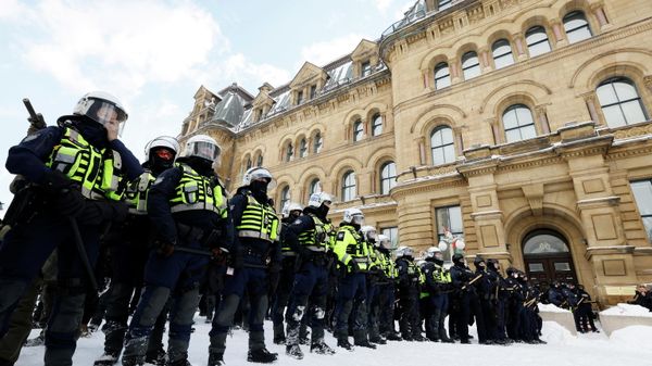 Canadian police officers stand guard as they work to restore normality to the capital while trucks and demonstrators continue to occupy the downtown core for more than three weeks to protest against pandemic restrictions in Ottawa, Ontario, Canada, February 19, 2022. Picture taken February 19, 2022 - Sputnik International