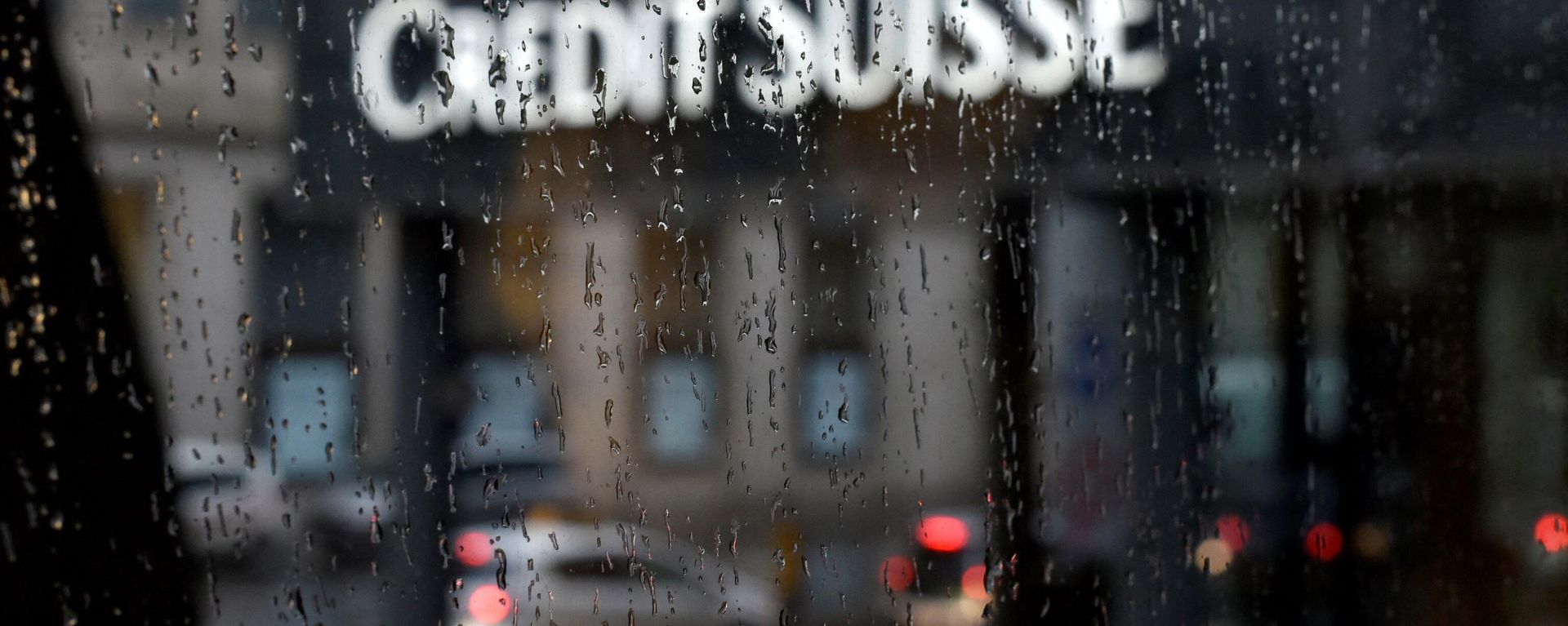 A picture taken on June 13, 2016 shows a branch of Swiss banking giant Credit Suisse behind a window under the rain, in Basel A picture taken on June 13, 2016 shows a branch of Swiss banking giant Credit Suisse behind a window under the rain, in Basel - Sputnik International, 1920, 23.02.2022