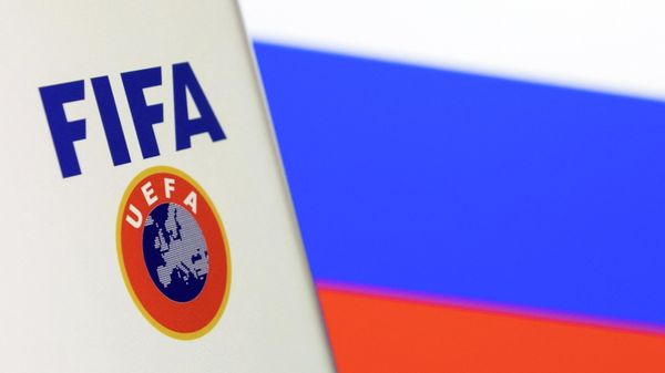 FIFA and UEFA logos are displayed in front of the Russian flag in this illustration taken, February 28, 2022 FIFA and UEFA logos are displayed in front of the Russian flag in this illustration taken, February 28, 2022 - Sputnik International
