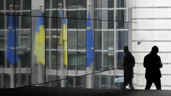 Ukraine and European Union flags are reflected onto a marble wall as a visitor walks by prior to an extraordinary plenary session on Ukraine at the European Parliament in Brussels, Tuesday, March 1, 2022 - Sputnik International