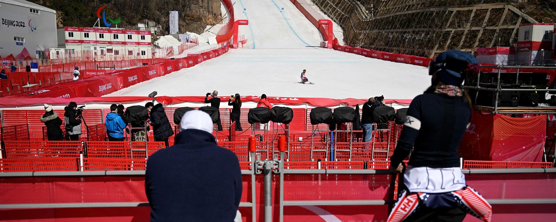 A paralympic athlete crosses the finish line during a training session for the men's downhill sitting event at the Yanqing National Alpine Skiing Centre in Yanqing ahead of the Beijing 2022 Winter Paralympic Games on March 3, 2022. A paralympic athlete crosses the finish line during a training session for the men's downhill sitting event at the Yanqing National Alpine Skiing Centre in Yanqing ahead of the Beijing 2022 Winter Paralympic Games on March 3, 2022. - Sputnik International, 1920, 04.03.2022