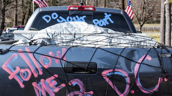 A written message reading follow me to D.C. is seen on the back of a truck as hundreds of vehicles including 18-wheeler trucks, RVs and other cars are parked as part of a rally at Hagerstown Speedway after some of them arrived as part of a convoy that travelled across the country headed to Washington D.C. to protest coronavirus disease (COVID-19) related mandates and other issues in Hagerstown, Maryland, U.S., March 5, 2022. - Sputnik International
