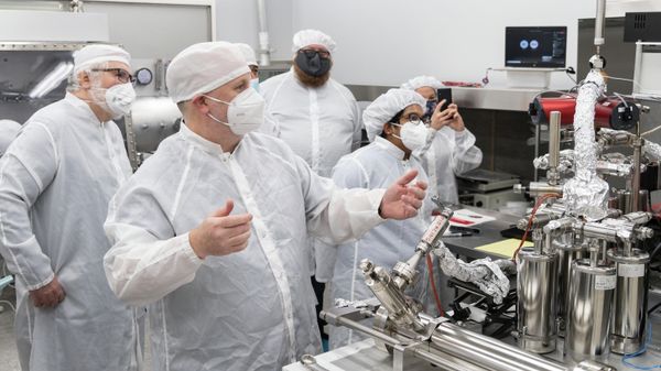 Front from left, Drs. Ryan Zeigler, Rita Parai, Francesca McDonald, Chip Shearer and back left from left, Drs. Zach Sharp from University of New Mexico and Francis McCubbin, Astromaterials Research and Exploration Science Division (ARES) astromaterials curator look on in excitement as gas is extracted into the manifold after the inner tube was pierced. - Sputnik International