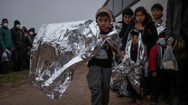 Issac, a seven year old unaccompanied migrant boy from Honduras, holds an emergency blanket as he is asked by a Customs and Border Protection official to board a bus after crossing the Rio Grande river into the United States from Mexico in Penitas, Texas, U.S., February 24, 2022 - Sputnik International