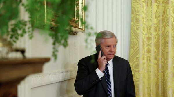 U.S. Senators Lindsey Graham (R-SC) uses his phone as he attends the signing into law of the Ending Forced Arbitration of Sexual Assault and Sexual Harassment Act of 2021, at the White House in Washington, U.S., March 3, 2022. - Sputnik International