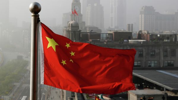 In this April 14, 2016 file photo, a Chinese national flag flutters against the office buildings in Shanghai, China.  - Sputnik International
