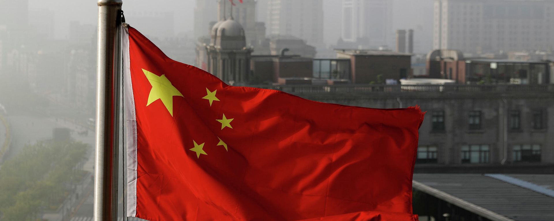 In this April 14, 2016 file photo, a Chinese national flag flutters against the office buildings in Shanghai, China. In this April 14, 2016 file photo, a Chinese national flag flutters against the office buildings in Shanghai, China. - Sputnik International, 1920, 03.08.2022