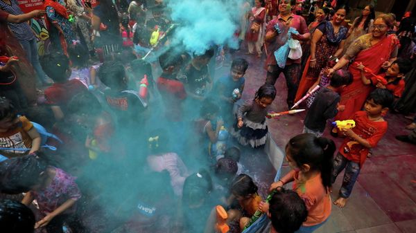 School children and their teachers play with coloured water and powder during Holi celebrations in Ahmedabad, India, March 17, 2022.  - Sputnik International